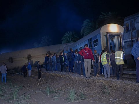 People view the damage after two trains have collided near the city of Sohag, Egypt, March 26, 2021. 