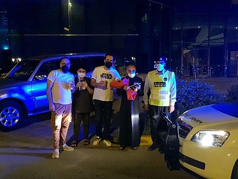 Sharjah Police officer Mohammad Hassan with Mazen Ahmad Al Khateib and his family.