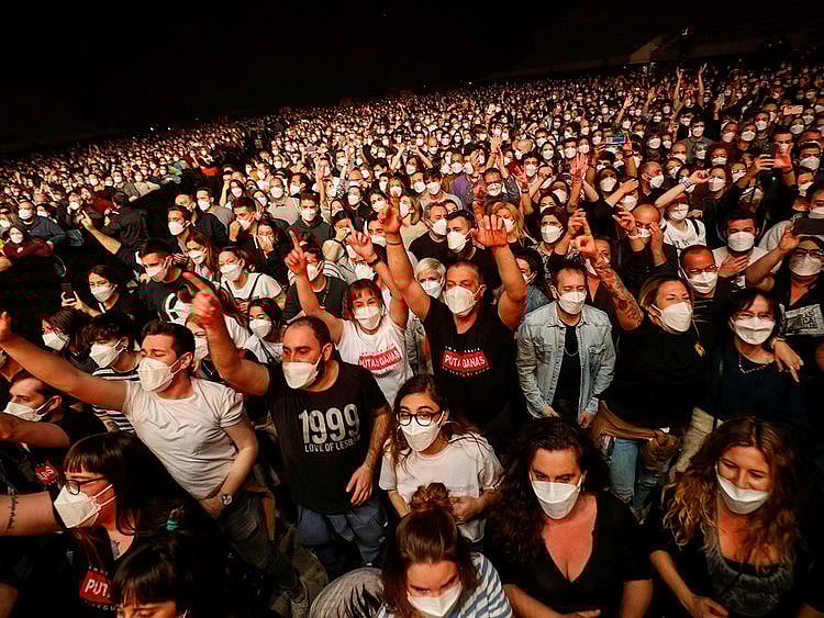 People wearing protective masks attend a concert of at the Palau Sant Jordi, the first massive concert since the beginning of the coronavirus disease (COVID-19) pandemic in Barcelona, Spain, March 27, 2021. 