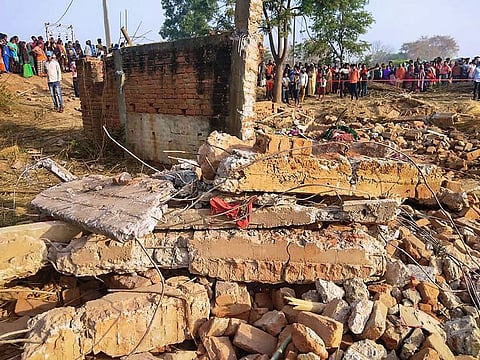 Giridih: People gather near the debris of a house that was blown up after a blast at Khirkiya village in Giridih district, Sunday, March 28, 2021. 