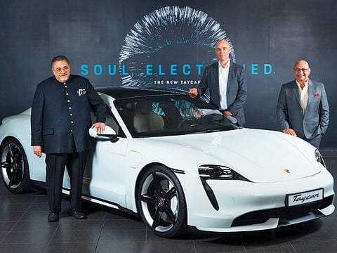 K. Rajaram, CEO of Al Nabooda Automobiles, and team seen with Porsche’s first all-electric car, the Taycan
