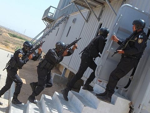 Newly trained police commandos perform anti-terror skills in Karachi. 