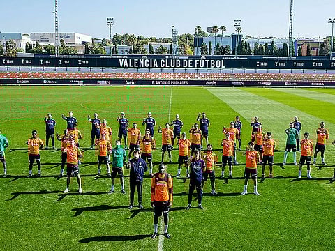 Valencia players and staff show their support to defender Mouctar Diakhaby as they protest against racism. Valencia's players walked off during their La Liga game with Cadiz on April 4 in protest against alleged racist abuse.