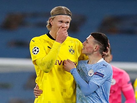 Men who would be king: Borussia Dortmund's Erling Braut Haaland (left) with Manchester City's Phil Foden after their Champions League quarter final match. City won the contest on aggregate and went on to make the final for the 2020-21 edition.