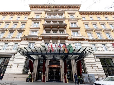 A police officer stands guard near the entrance of the Grand Hotel in Vienna on April 6, 2021, where diplomats of the EU, China, Russia and Iran held talks. 