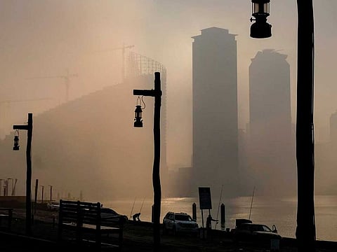 People during the foggy morning in Sharjah.