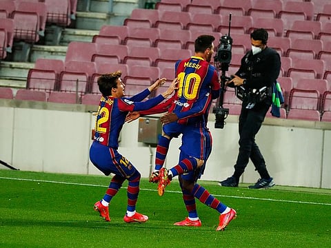 Barcelona's Ousmane Dembele celebrates with Lionel Mess after scoring against Valladolid