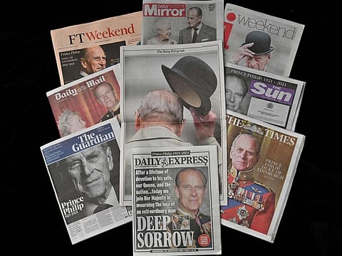 A spread shows the front pages of British newspapers reporting on the death of Britain's Prince Philip, Duke of Edinburgh, is pictured in Brighton, south England on April 10, 2021. 