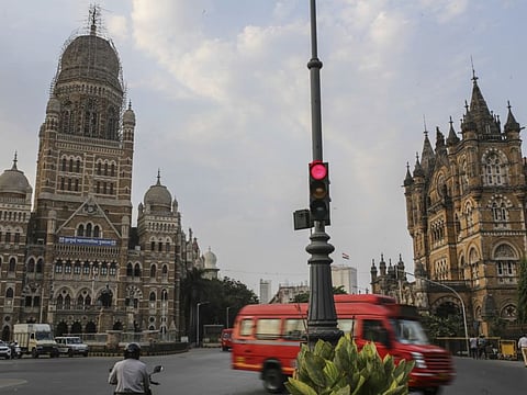 Vehicles drive past the Municipal Corporation Building during a lockdown in Mumbai, India, on Saturday, April 10, 2021. Maharashtra has halted all non-essential services, ordered private companies to work from home, and shut malls and restaurants through April. Photographer: Dhiraj Singh/Bloomberg