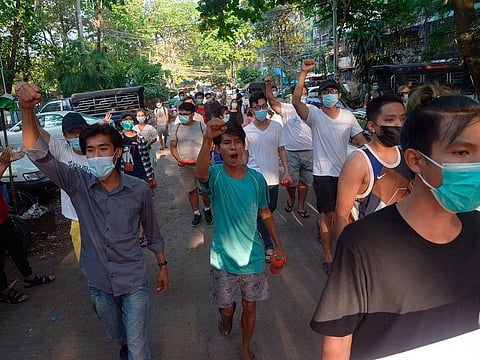 People march to protest against the military coup in February, in Yangon, Myanmar.