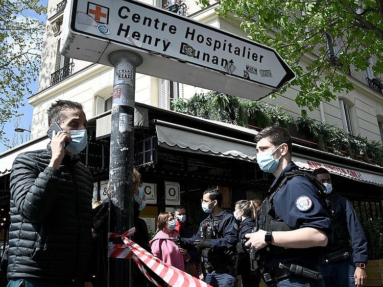 French police cordon off the area near the Henry Dunant private hospital where one person was shot dead and one injured in a shooting outside the instituion owned by the Red Cross in Paris' upmarket 16th district on April 12, 2021. 