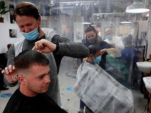 People get their hair cut at a busy hairdressers in London, Monday, April 12, 2021. 