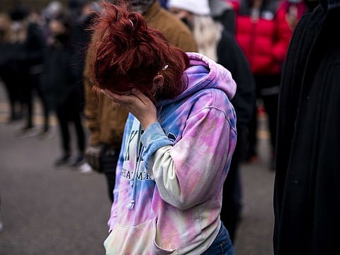 A person reacts in the midst of a prayer during a vigil for Daunte Wright on April 12, 2021 in Brooklyn Center, Minnesota.