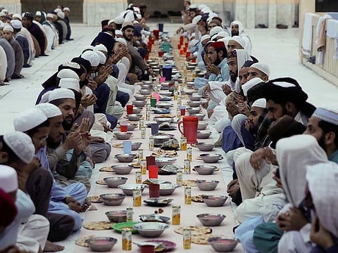 People pray before Iftar (breaking fast) during the fasting month of Ramadan, as the outbreak of the coronavirus disease (COVID-19) continues, at a mosque in Peshawar, Pakistan April 14, 2021. 