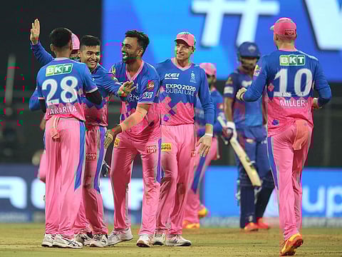 Rajasthan Royals players celebrate the fall of a wicket during their campaign in IPL 2021 in India.