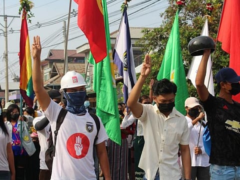 Demonstrators flash a three-finger salute during a protest against the military coup in Dawei, Myanmar.