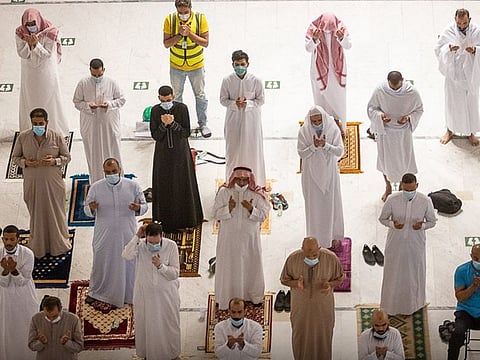 Worshippers pray inside the Grand Mosque in Ramadan amid strict health precautions.