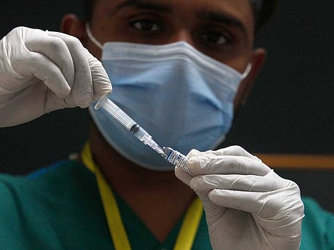 A health worker prepares a Sputnik V COVID-19 vaccine at a private hospital, in Karachi, Pakistan, Tuesday, April 6, 2021. 
