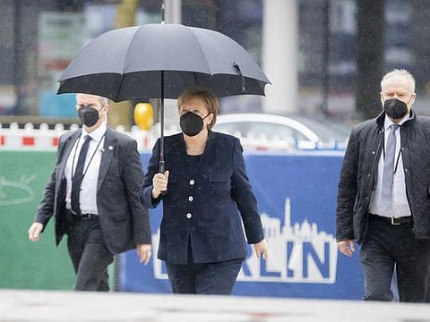 German Chancellor Angela Merkel arrives with an umbrella in the rain for an ecumenical service at the Kaiser Wilhelm Memorial Church to mark the central commemoration of those who died in the Corona pandemic in Germany, Berlin.