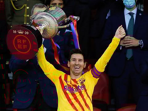FC Barcelona's Lionel Messi celebrates winning the Copa del Rey with the trophy.