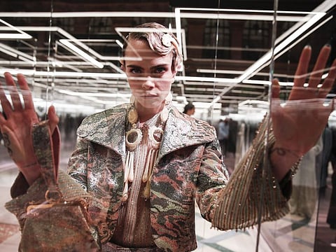 File photo, model Cara Delevingne wears a creation for Fendi's Spring-Summer 2021 Haute Couture fashion collection presented in Paris. The pandemic has torn a multibillion-dollar bite out of the fabric of Europe's luxury industry, stopped runway shows and forced brands to show their designs digitally instead. Now, amid hopes of a return to near-normality by the year’s end, the industry is asking what fashion will look like as it dusts itself and struggles to its well-heeled feet again. 