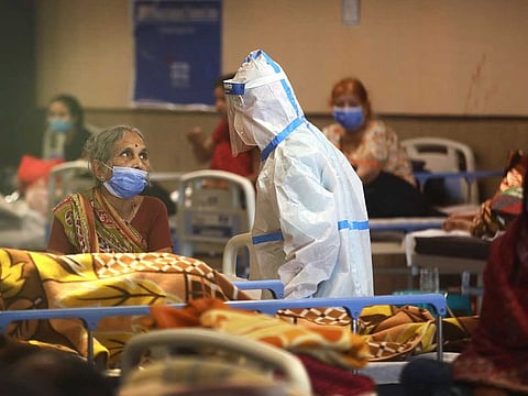 A health worker talks to a woman in a quarantine centre for COVID-19 patients, in New Delhi, India, Monday, April 19, 2021. 