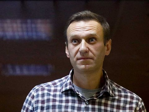 In this Saturday, Feb. 20, 2021 file photo, Russian opposition leader Alexei Navalny stands in a cage in the Babuskinsky District Court in Moscow, Russia. Russian state penitentiary service says a decision has been made to transfer imprisoned Russian opposition leader Alexei Navalny, who is in the third week of a hunger strike, to a hospital. 