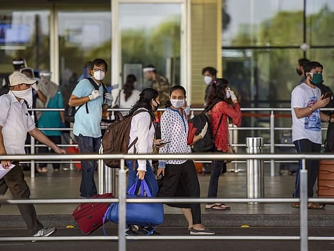 Passengers stand in a queue as they arrive at Chhatrapati Shivaji Maharaj International Airport in Mumbai earlier. Many Indian expats have put off their travel plans from UAE to India in view of the current situation over the COVID-19 pandemic in India.