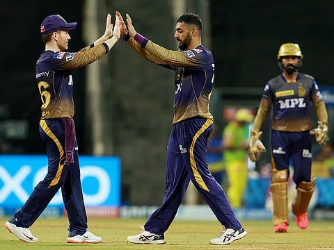 Varun Chakravarthy of Kolkata Knight Riders (centre) celebrates after taking the wicket of Ruturaj Gaikwad of Chennai Super Kings in IPL 2021. 