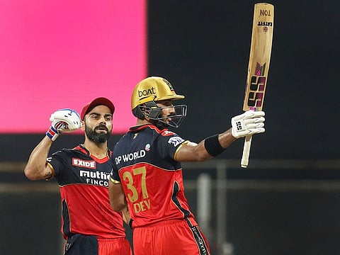 Well played: Virat Kohli (left) lauds Devdutt Padikkal as the latter completes a match-winning century on Thursday. 