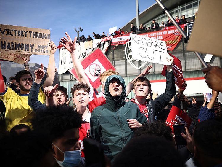 Fans protest against Arsenal owner Stan Kroenke ahead of the game against Everton
