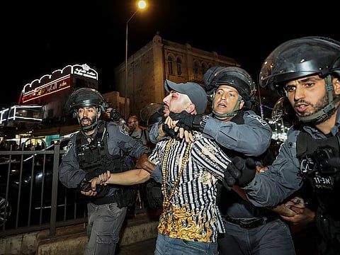 Israeli police detain a man outside Damascus Gate after barriers that were put up by Israeli police are removed, allowing access to the main square that has been the focus of a week of clashes around Jerusalem's Old City April 25, 2021.