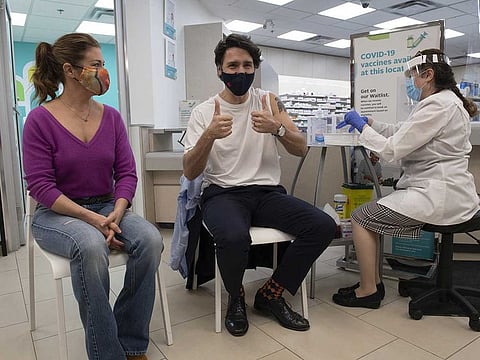 Justin Trudeau, Canada's prime minister, gives a thumbs up before receiving a dose of the AstraZeneca COVID-19 vaccine with his wife Sophie Grgoire Trudeau, left, in Ottawa, Ontario, Canada, on Friday, April 23, 2021.
