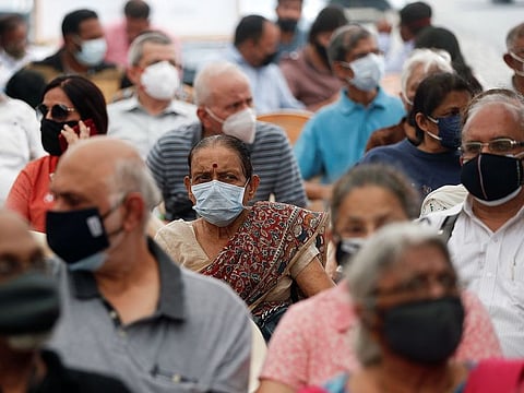 People wait to receive a dose of COVISHIELD, a COVID-19 vaccine manufactured by Serum Institute of India, during a vaccination drive for people above 60 years of age and those who are 45 or more and suffering from certain medical conditions, in Mumbai, India.