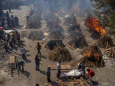 Multiple funeral pyres of victims of COVID-19 burn at a ground that has been converted into a crematorium for mass cremation in New Delhi, India, Saturday, April 24, 2021. 