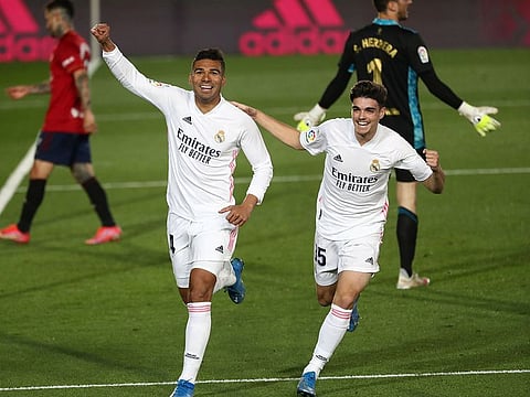 Real Madrid's Casemiro celebrates scoring their second goal with Miguel Ortega Gutierrez.
