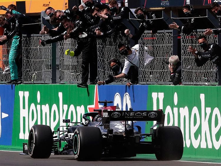 Lewis Hamilton is greeted by the Mercedes team after his win in Portugal