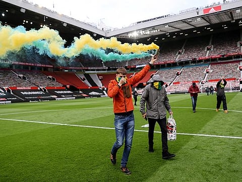 Manchester United fans invade the pitch in protest against club owners.