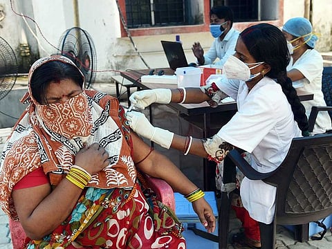 A medic administers a COVID-19 vaccine to a beneficiary at a government dispensary, during the second wave of the coronavirus pandemic, in Patna.