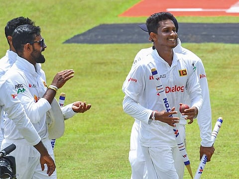 Sri Lanka's left-arm spinner Praveen Jayawickrama (front) walks off the field after his Man of the Match winning performance against Bangladesh on Tuesday.