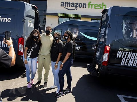 Amazon Fresh store associates and nonprofit partner Village for Vets volunteers posed for photos with actor Michael B. Jordan, who stopped by during the promotion of the launch of 'Tom Clancy's Without Remorse'; on Prime Video, to help load care packages of food and household items at the Ladera Heights neighborhood store in Los Angeles, CA, Thursday, April 29, 2021. (Jay L. Clendenin/ Los Angeles Times/TNS), lang="x-repair" Amazon Fresh store associates and nonprofit partner Village for Vets volunteers posed for photos with actor Michael B. Jordan, who stopped by during the promotion of the launch of &quot;Tom Clancy&apos;s Without Remorse,&quot; on Prime Video, to help load care packages of food and household items at the Ladera Heights neighborhood store in Los Angeles.
