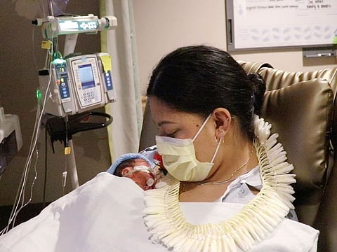 Lavinia "Lavi" Mounga holds her son Raymond Mounga at Kapiolani Medical Center for Women & Children in Honolulu.  