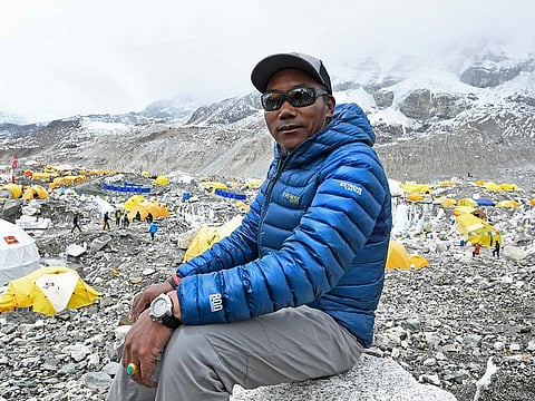 In this photograph taken on May 2, 2021, Nepal's mountaineer Kami Rita Sherpa poses for a picture during an interview with AFP at the Everest base camp in the Mount Everest region of Solukhumbu district, as Sherpa on May 7 reached the summit of Mount Everest for the 25th time, breaking his own record for most summits of the highest mountain in the world. 