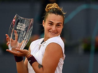 Belarus' Aryna Sabalenka poses with her trophy after beating Australia's Ashleigh Barty during their 2021 WTA Tour Madrid Open tennis tournament singles final match at the Caja Magica in Madrid on May 8, 2021.