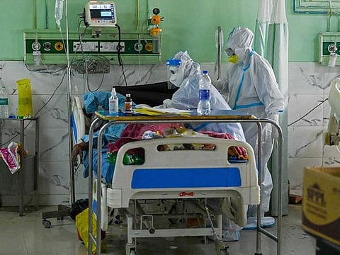 In this picture taken on May 5, 2021, health workers wearing personal protective equipment (PPE) suits attend to a COVID-19 coronavirus patient inside the Intensive Care Unit (ICU) of the Teerthanker Mahaveer University (TMU) hospital in Moradabad.   