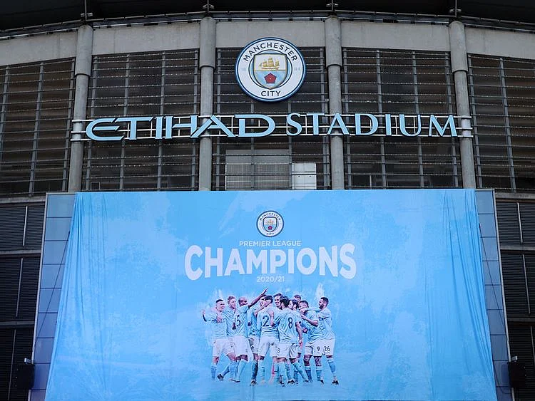 A flag is unfurled at Etihad Stadium proclaiming Manchester City as champions