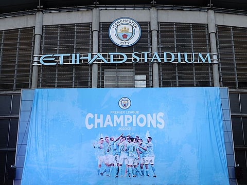 A flag is unfurled at Etihad Stadium proclaiming Manchester City as champions