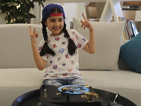 Michelle Rasul flashes a rockstar sign in the lobby of her apartment building in Dubai. Rasul, a 9-year-old girl from Azerbaijan who lives in Dubai, is scratching her way to the top as a DJ after competing in the DMC World DJ Championship. 