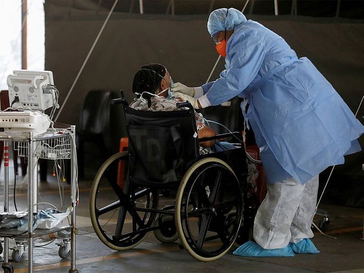 A healthcare worker tends to a patient