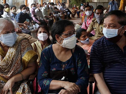 People wait to receive vaccine for COVID-19 outside a vaccination centre in Mumbai, India, Thursday, May 13, 2021. 